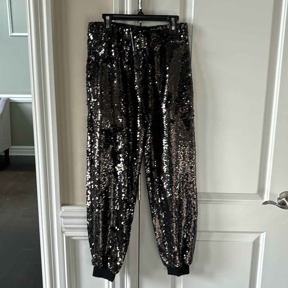 NWT black sequined pull on pants with cinched cuffs and pockets.